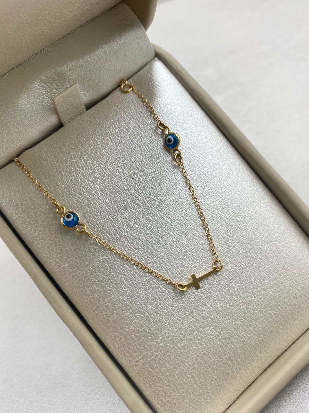 Pulso It aro seguido ojo turco con herraje cruz Oro amarillo 18k 1,40 Gr / 1,02 mm / 19 Cm